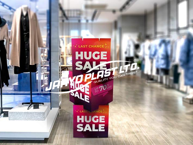 Stacked sale dump bin printed in pink and red in a clothing store