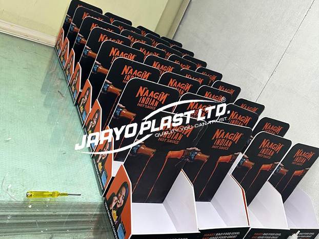 Rows of printed PP counter displays for a hot sauce brand