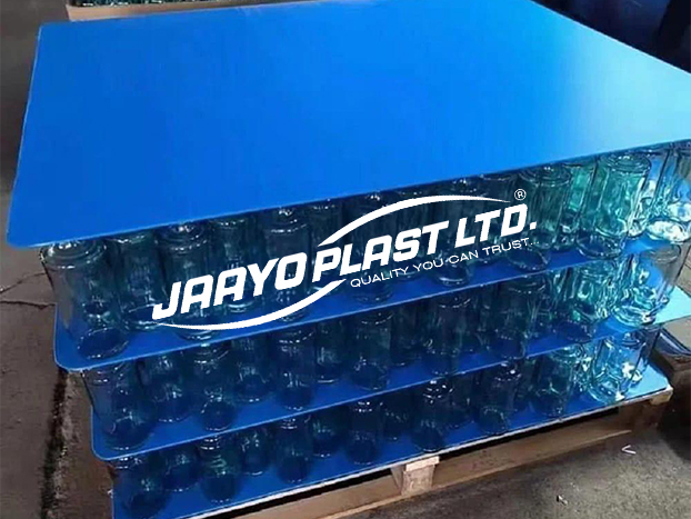 Bottles stacked on grey PP layer pads